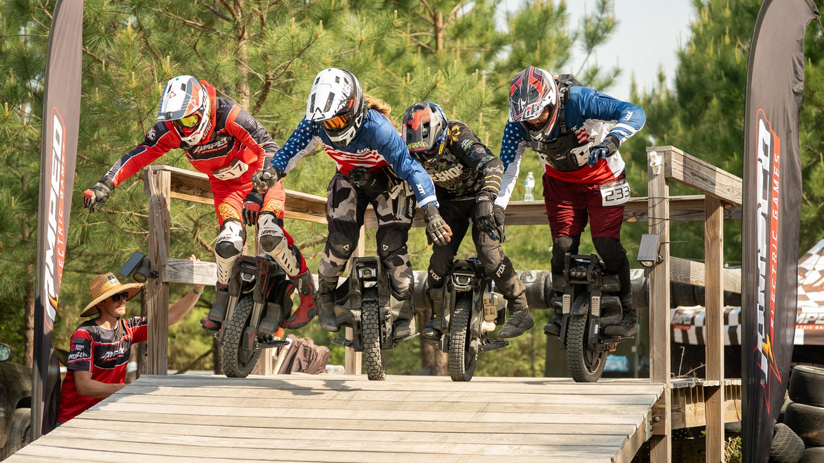 Four electric unicycle racers drop off the start ramp side by side at Oak City Shredfest. Photo: USA EUC
