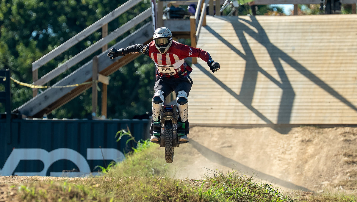 Bennett Schirmer racing electric unicycle on the Flow Track at Amped 2025